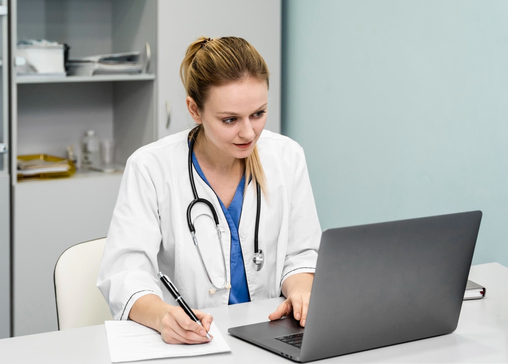 female doctor working at a computer
